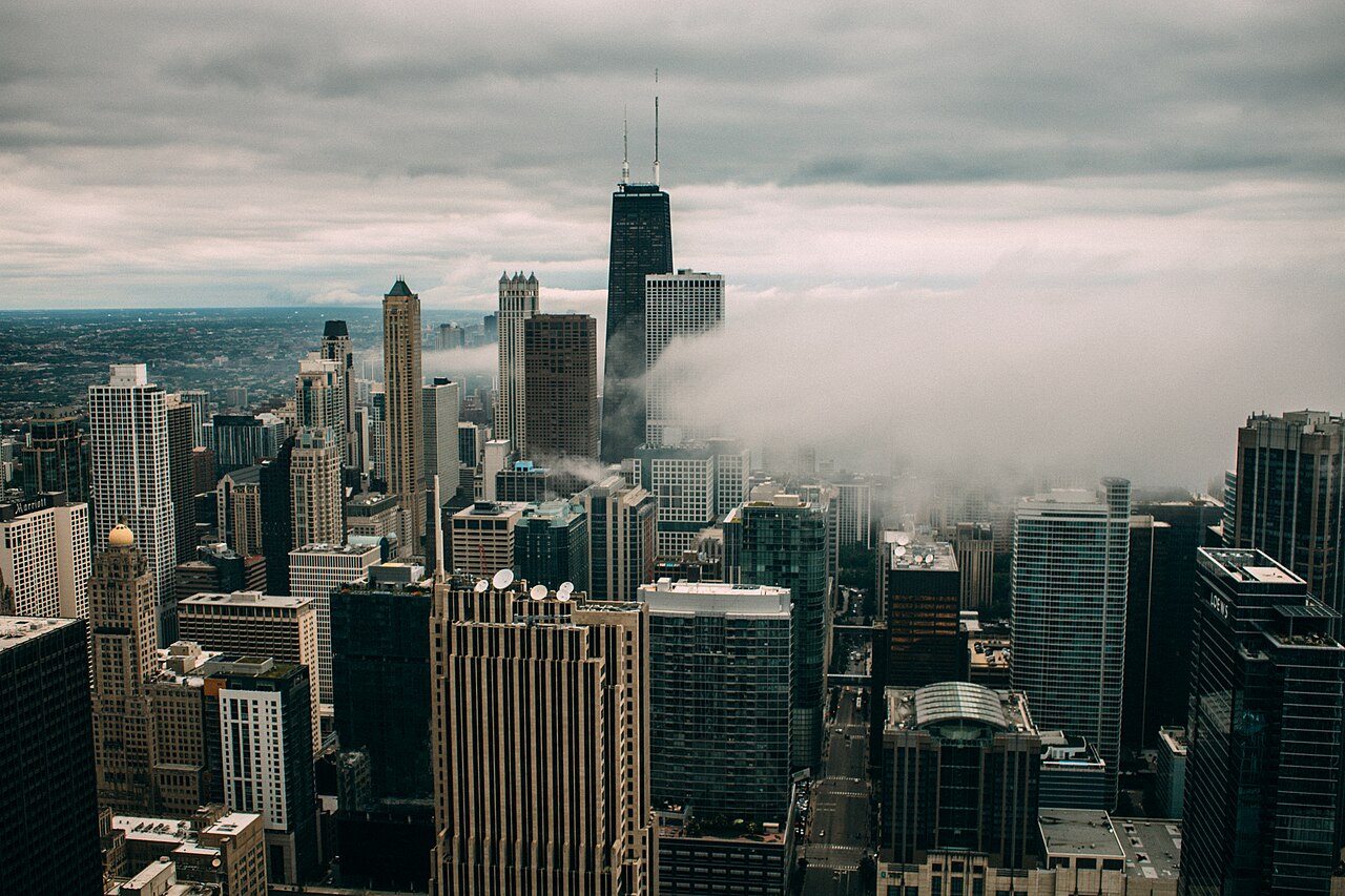 Chicago skyline rising through low clouds